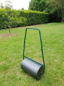 metal hand lawn roller in yard